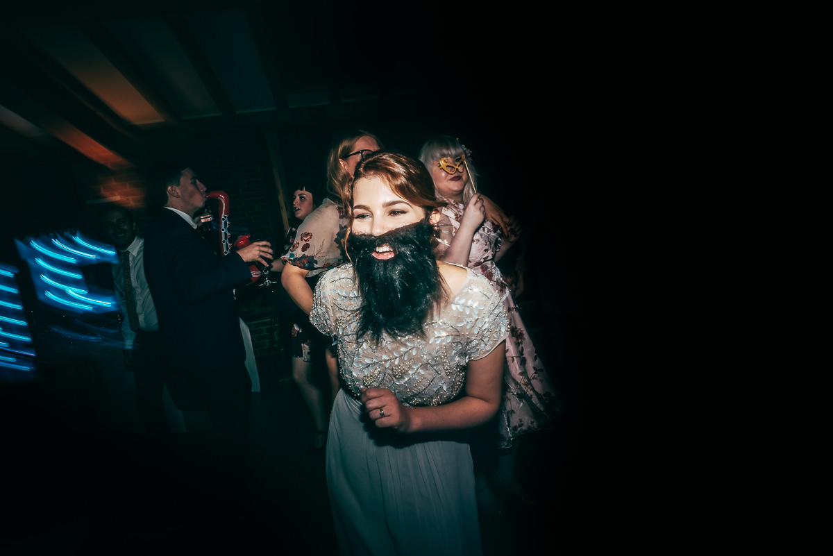 bridesmaid dancing in fake beard